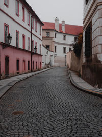 Empty alley amidst buildings in city