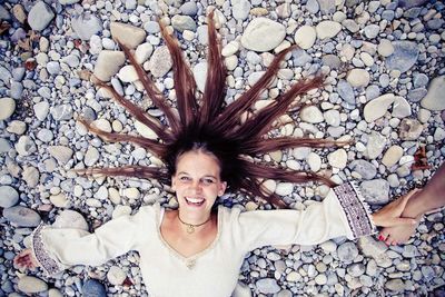 Portrait of young woman with hair arranged on ground