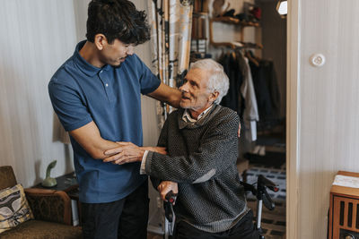 Senior man thanking male healthcare worker at home