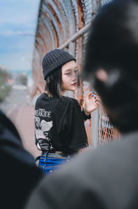 Portrait of a young woman sitting outdoors