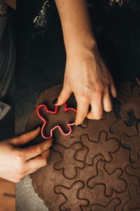 Cropped hands of man holding jigsaw piece