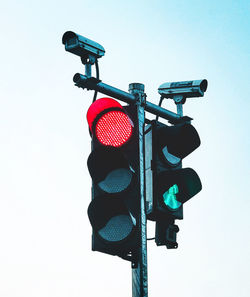 Low angle view of road signal against sky
