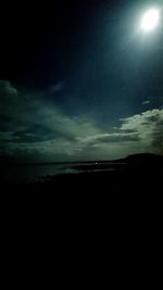 Scenic view of beach against sky at night