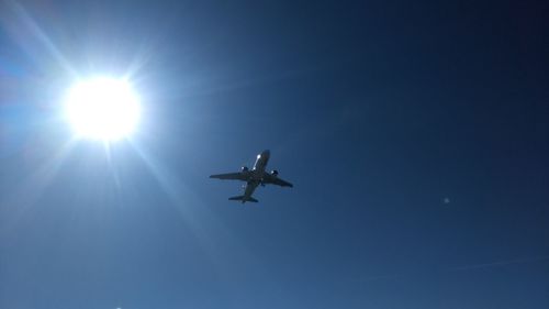 Low angle view of airplane flying in sky