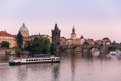 Boats in river with buildings in background