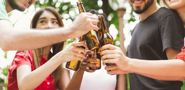 Friends toasting beer bottles