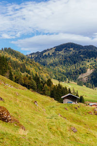 Scenic view of trees and houses against sky