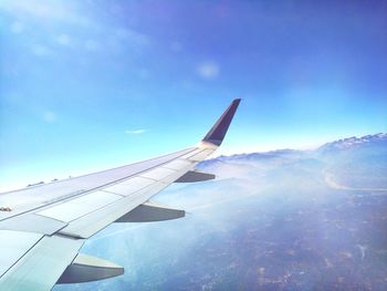 Aerial view of airplane wing against clear blue sky