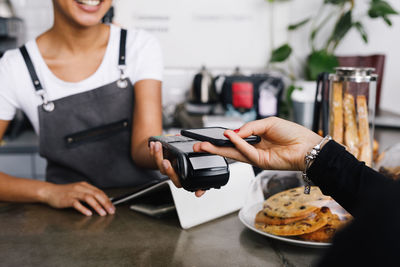 Close-up of woman using mobile phone in restaurant