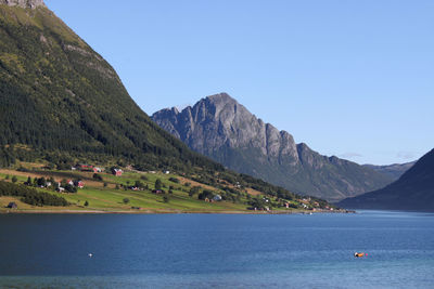 Scenic view of mountains against clear blue sky