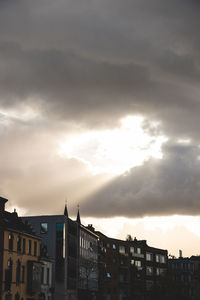 Buildings in city against sky during sunset