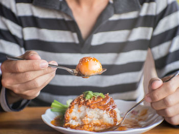 Close-up of man eating food in restaurant