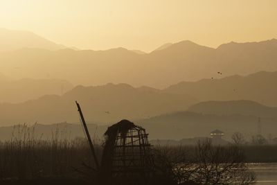 Silhouette mountains against sky during sunset