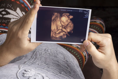 Midsection of woman using mobile phone