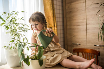 Woman sitting on table at home