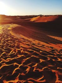 Scenic view of desert une against clear sky