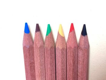 Close-up of multi colored pencils against white background