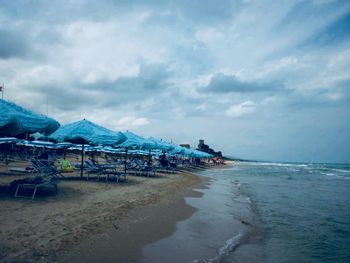 View of beach against cloudy sky