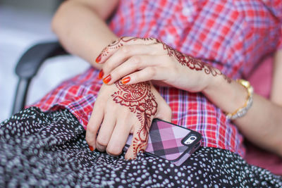 Midsection of woman holding hands