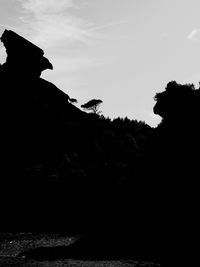 Low angle view of silhouette mountain against sky