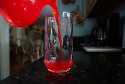 Close-up of red wine glass on table