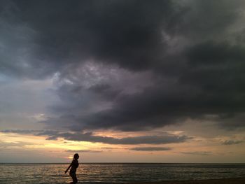 Man standing on beach during sunset