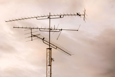 Low angle view of television aerial against sky