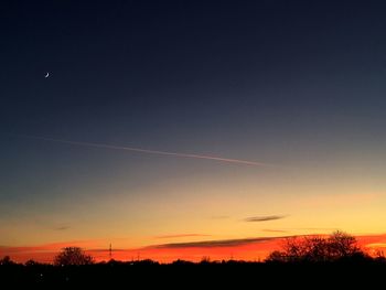 Silhouette trees against sky during sunset