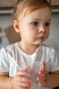 Close-up of cute boy eating food at home