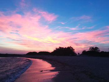 Scenic view of beach against sky during sunset