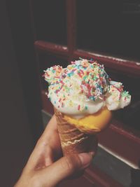 Close-up of hand holding ice cream cone