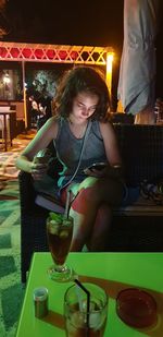 Young woman sitting at restaurant table