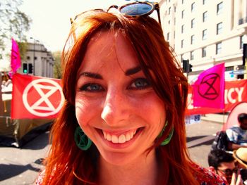 Portrait of smiling young woman in city