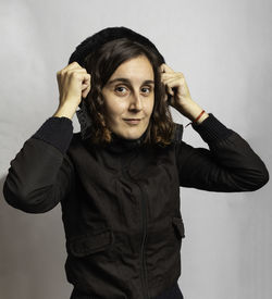 Portrait of woman standing against white background