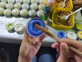 High angle view of hand holding multi colored candies