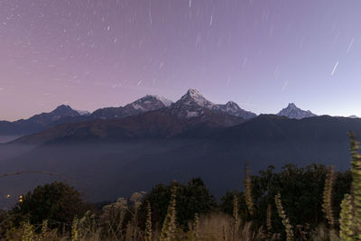 Scenic view of mountains against sky at night