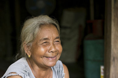 A close-up of a single indigenous woman smiling