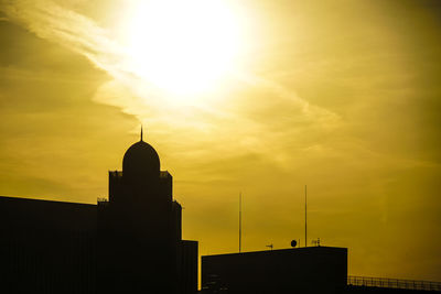 Low angle view of buildings against sky during sunset