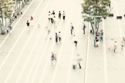 Group of people walking on road in city