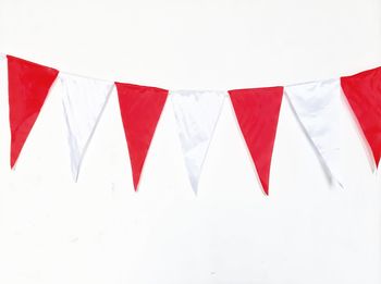 Low angle view of flags against white background