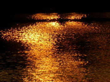 Scenic view of lake against sky at night