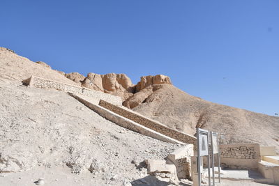 Panoramic view of desert against clear blue sky