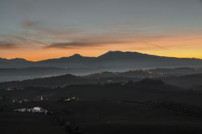 Scenic view of silhouette mountains against sky during sunset