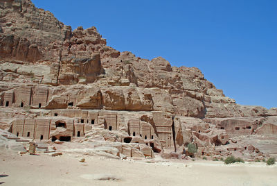 Low angle view of old ruins against clear blue sky