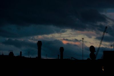 Silhouette landscape against cloudy sky