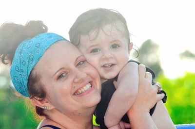 Portrait of smiling woman with baby girl