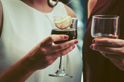 Midsection of woman holding drink