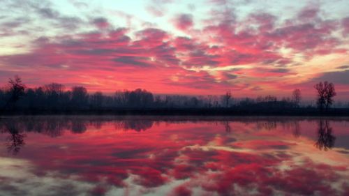 Scenic view of lake against sky during sunset