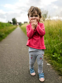 Full length of cute girl walking on footpath