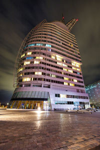 Low angle view of illuminated building against sky at night